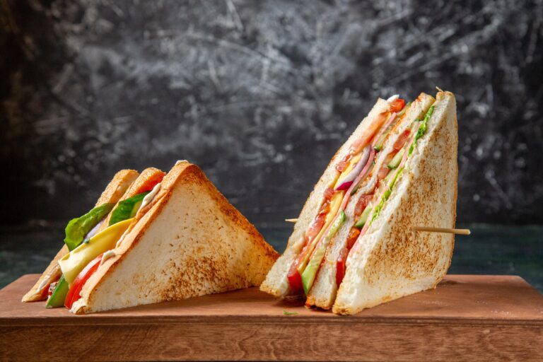 front-view-delicious-ham-sandwiches-wooden-board-dark-surface